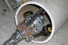 Early model, built of pipe fittings, walnut hardwood, and lego wheels, is inserted into the pipe.